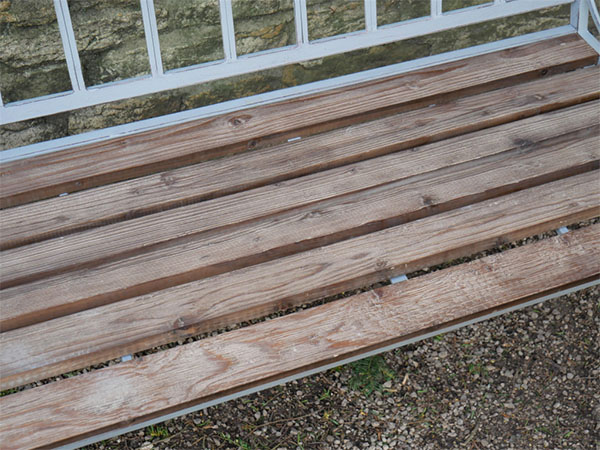 Antique Grey Iron / Fir Wood Garden Bench - Close up image showing the wood on the bench seat and part of the metal frame