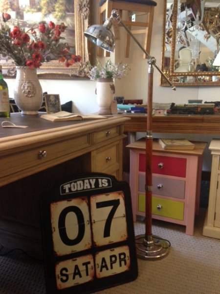 Edison Vintage Lighting Wood / Nickel Telescopic Floor Standing Lamp on display with a small partners desk and a contemporary metal flip style calendar in our showrooms